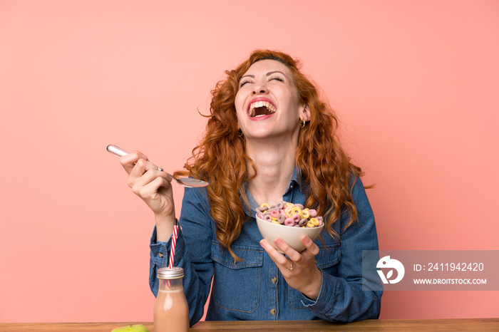 Happy Redhead woman having breakfast