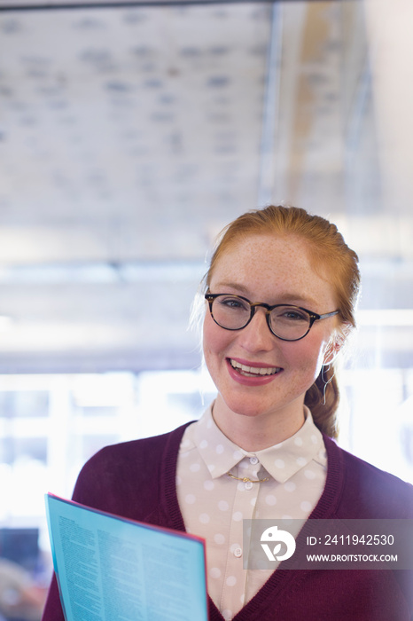 Portrait happy young businesswoman in office