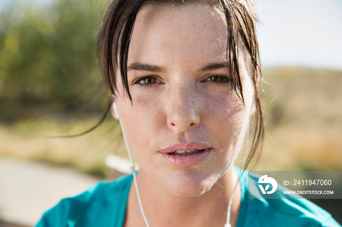 Close-up of woman sweating during outdoor workout.