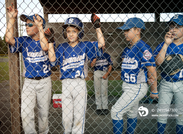 Baseball players standing in dugout