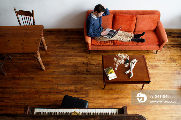 High angle view of man using laptop while sitting at home