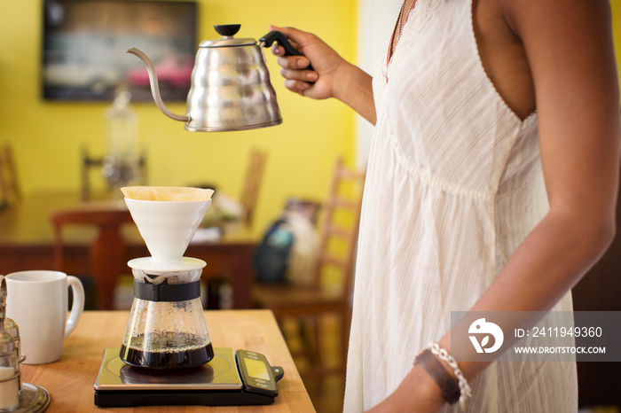 Young woman preparing coffee