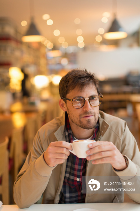 Man drinking cappuccino in cafe