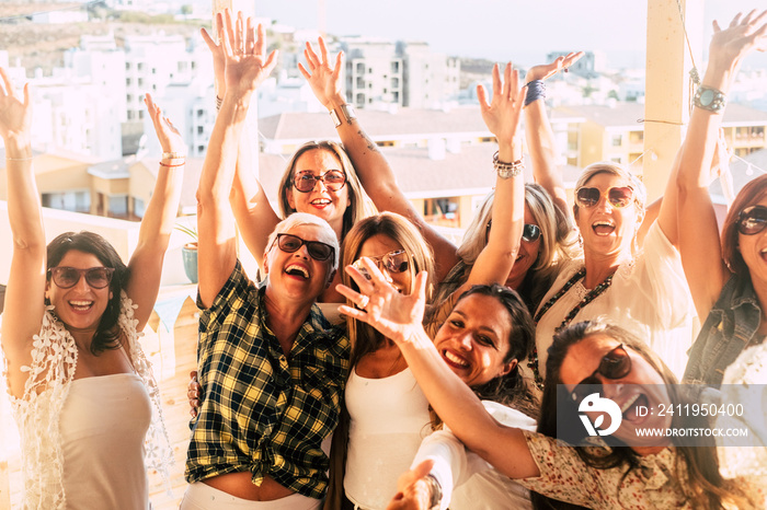 Happy and cheerful group of women friends together dancing and having fun on the rooftop at home - p