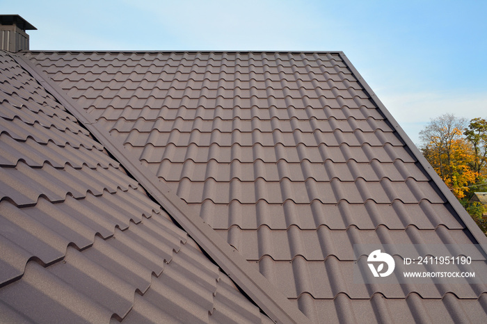 Metal Roof Construction Against Blue Sky. Roofing materials. Metal House roof. Closeup House Constru