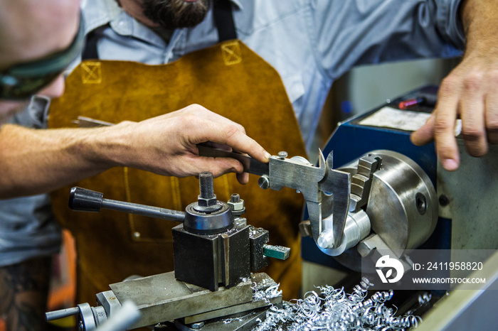 Two mechanics working at workbench