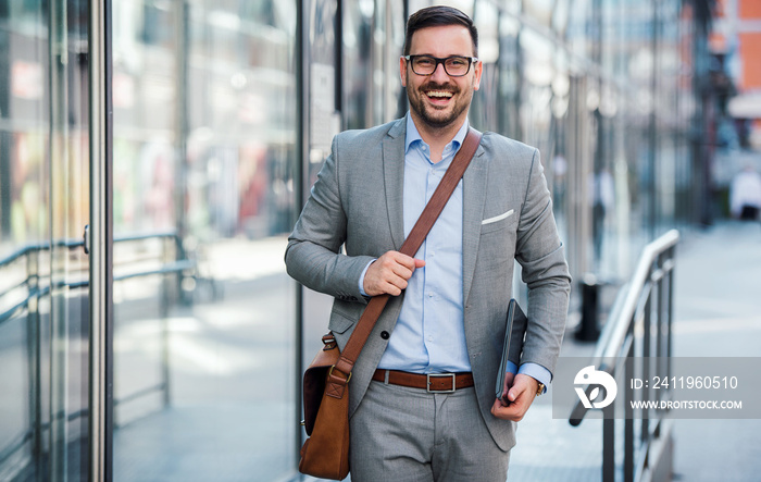 Young smiling businessman on the way to the office. Business, education, lifestyle concept