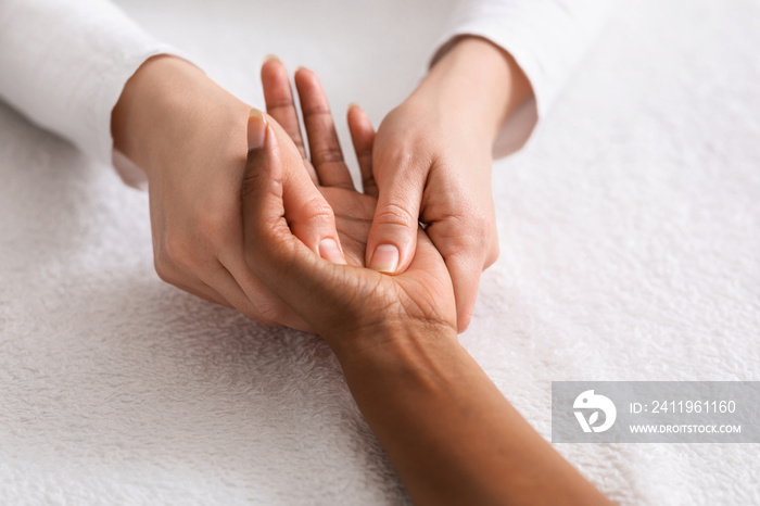 Relaxing hand massage for unrecognizable african lady