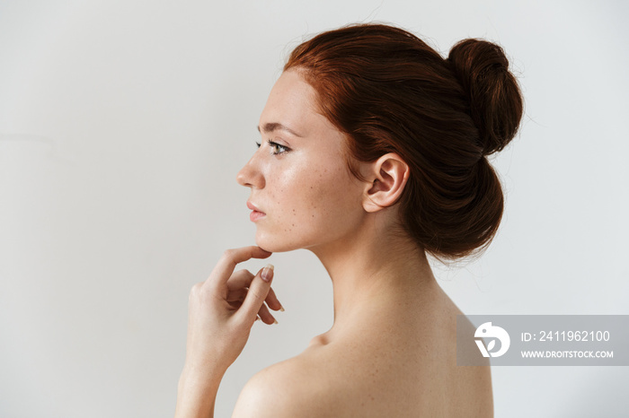 Beauty portrait of an attractive young topless redhead woman