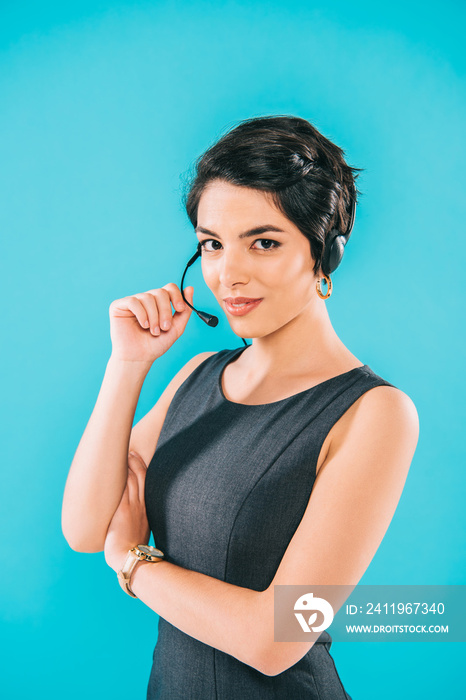 attractive mixed race call center operator looking at camera isolated on blue