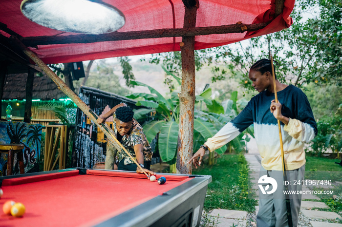 Queer masculine women playing pool