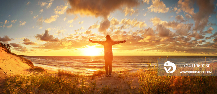 View of a happy woman on the sunset beach