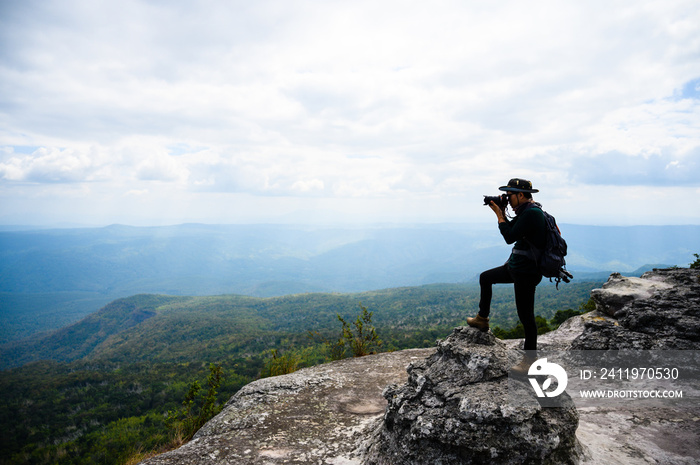 Male photographer traveling and photographing mountains