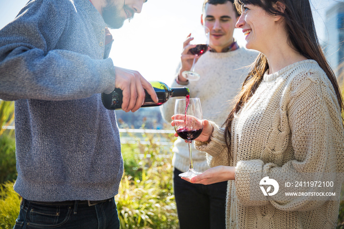 Man pouring wine from bottle into wineglass