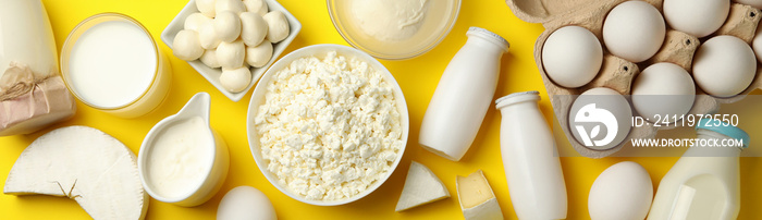 Different fresh dairy products on yellow background, top view