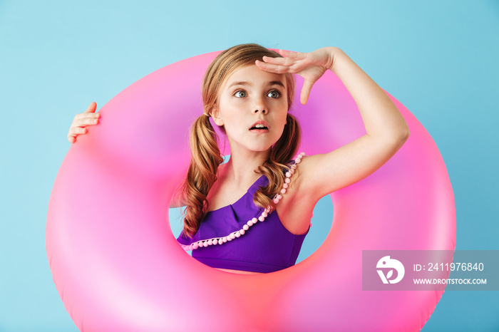 Cheerful little girl wearing swimsuit standing i