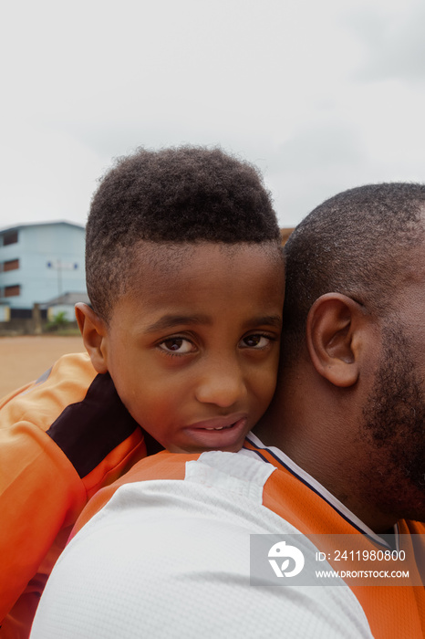 Boy and father on soccer field