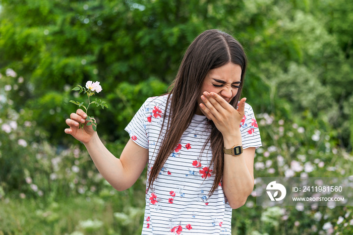 Young woman with Pollen allergy holding a flower and saying no.. Young woman with pollen and grass a