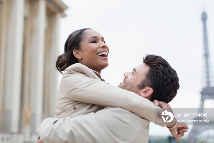 Happy couple hugging near Eiffel Tower, Paris, France