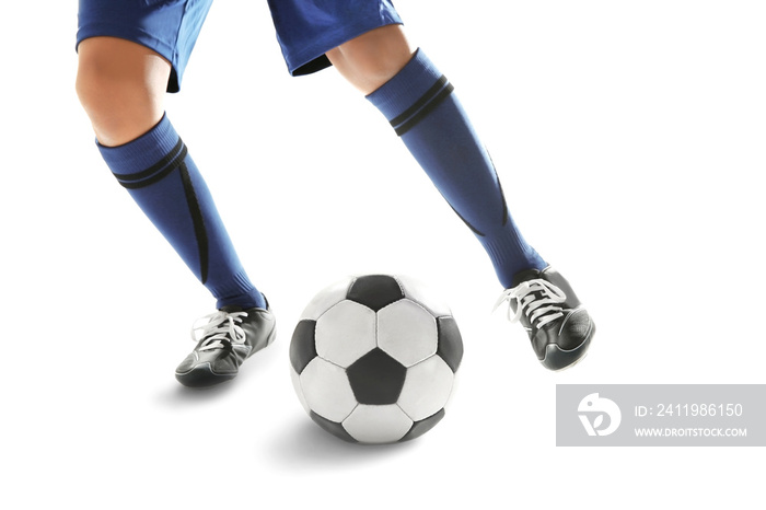 Legs of young man playing football on white background