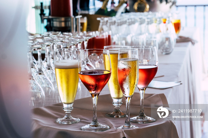餐厅的一套彩色玻璃杯，里面有葡萄酒和啤酒——庆祝活动和儿茶素的概念