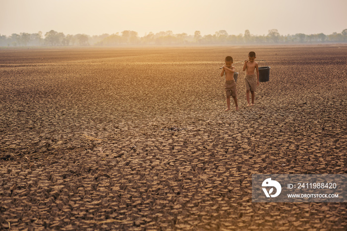 Asian local boys at large dry cracked land metaphor Life searching for water, Climate change, Enviro