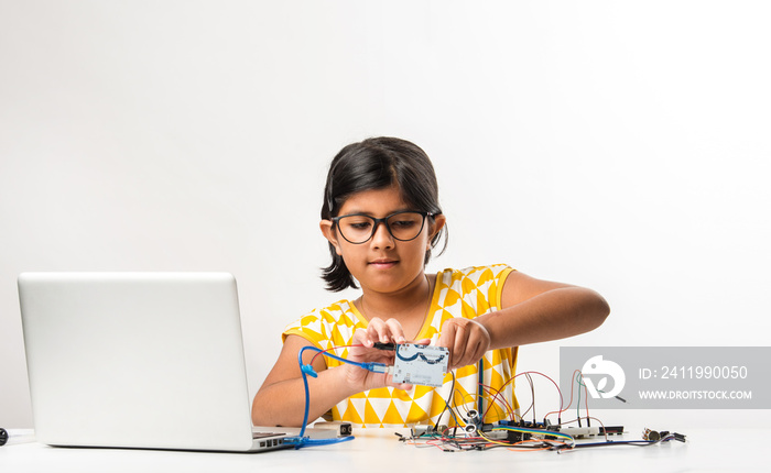 Electronic experiment - Indian girl student working with wires and connections inventing something