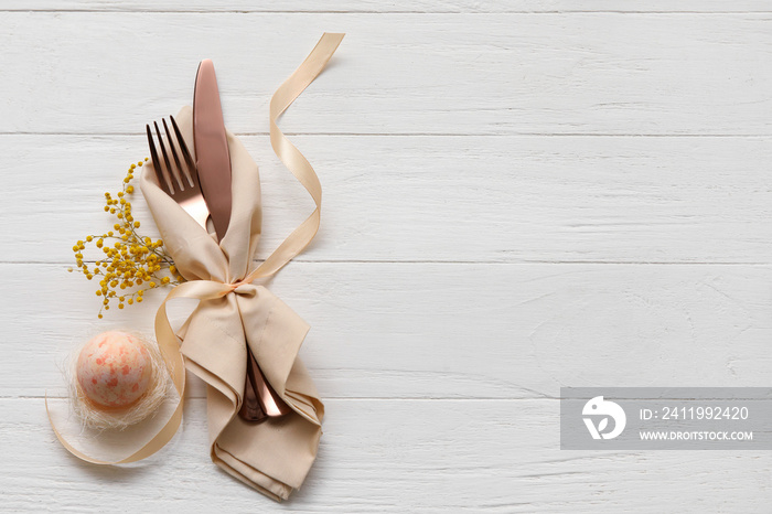 Stylish table setting for Easter celebration on white wooden background