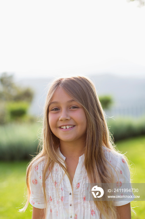 Portrait happy girl in sunny backyard