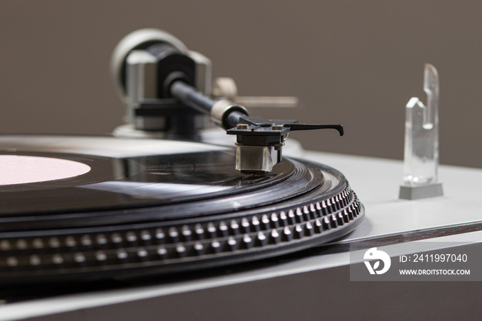 An old antique turntable with melodies - gramophone. Vintage record player spins