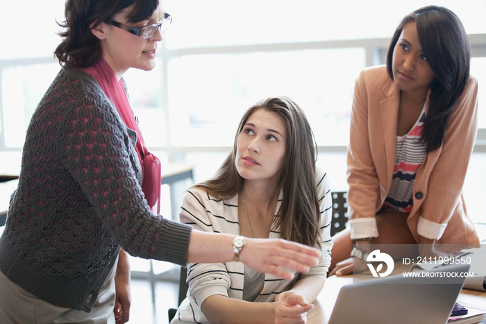 college instructor assisting female students