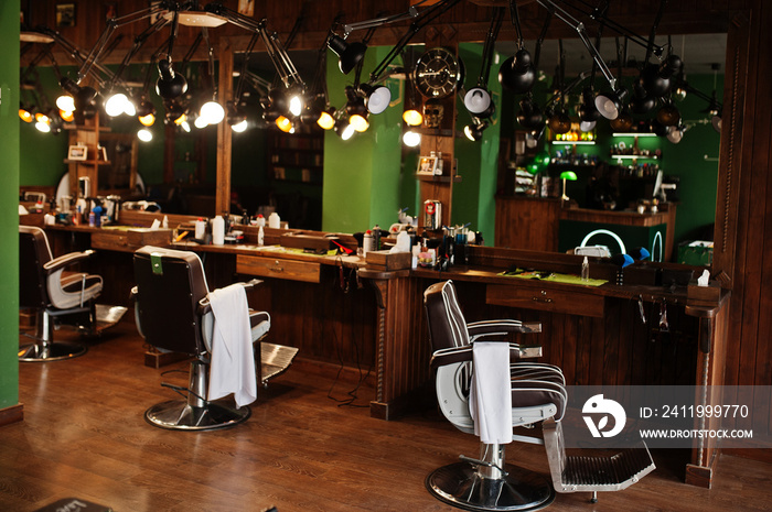 Brown vintage leather chairs at stylish barber shop.