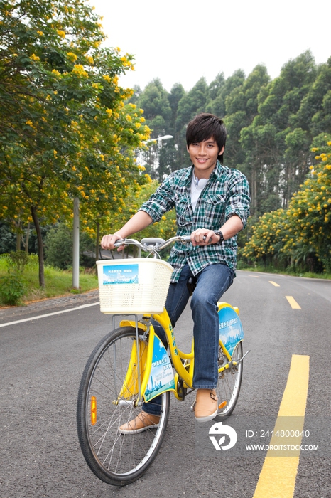 年轻大学生在校园里骑车