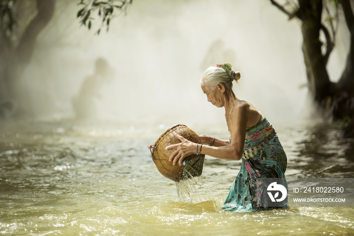 old woman looking for fish streams.