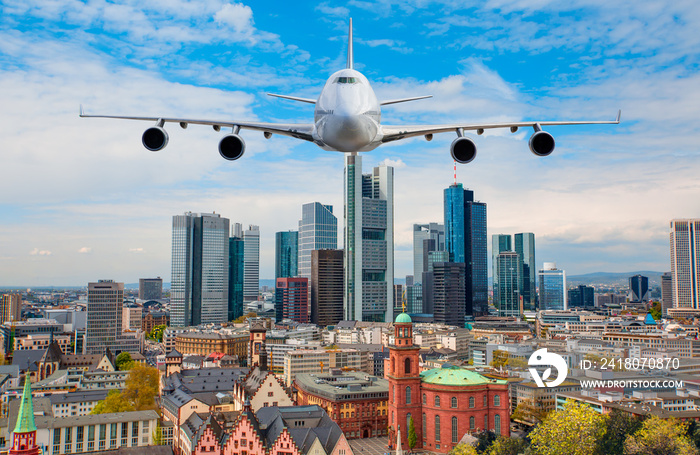 Airplane flying over business skyline of Frankfurt am Main, Germany - financial capital of the europ