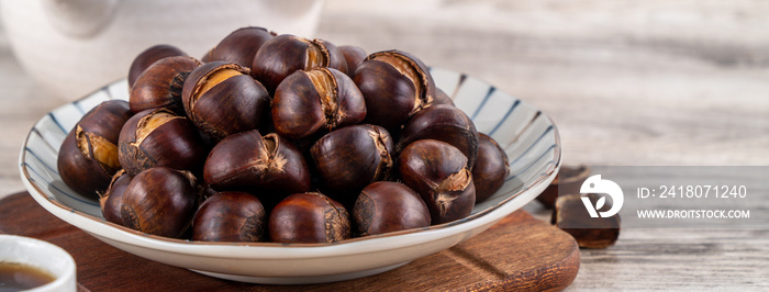 Close up of delicious roasted chestnuts with oil for eating.