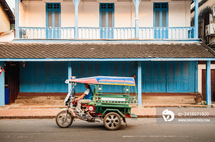 Colonial building and Tuk Tuk Skylab on Luang Prabang street, Laos