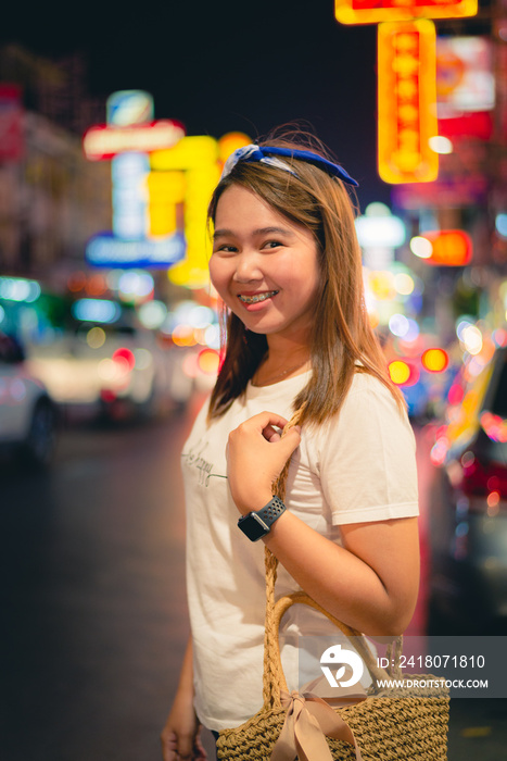 Asian young woman travel in China town at Thailand at Night,Woman travel and eating Night street foo