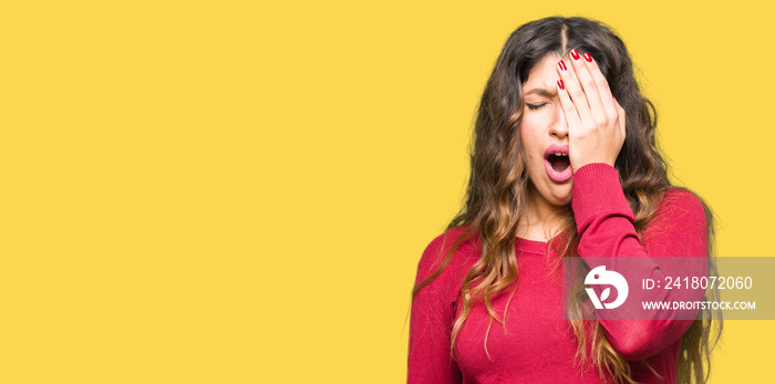 Young beautiful woman wearing red sweater Yawning tired covering half face, eye and mouth with hand.