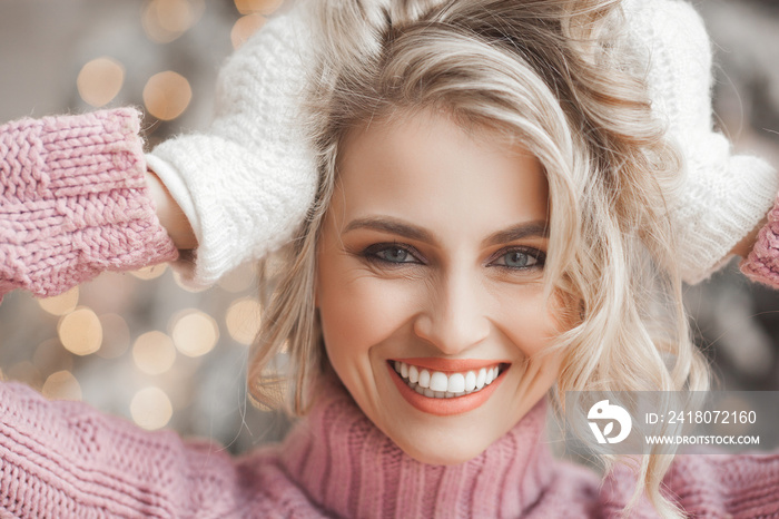 Close up portrait of young beautiful woman on Christmas background. Smiling girl with perfect skin n