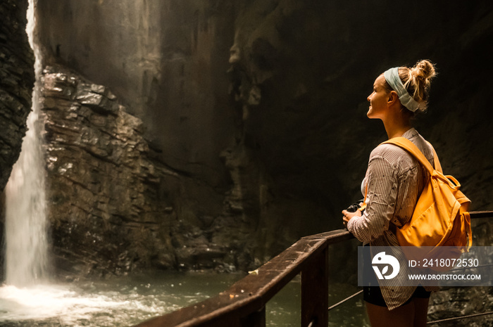 Woman standing at the edge and looking at wonderful scenery. Kozjak waterfall one of the beautiful w