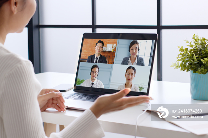 Young Asian businesswoman work at home and virtual video conference meeting with colleagues business