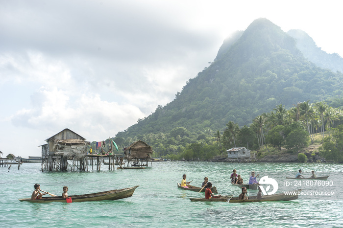 Unidentified Bajau Laut kids on a boat in Bodgaya Island, Sabah, Malaysia. They lived in a house bui