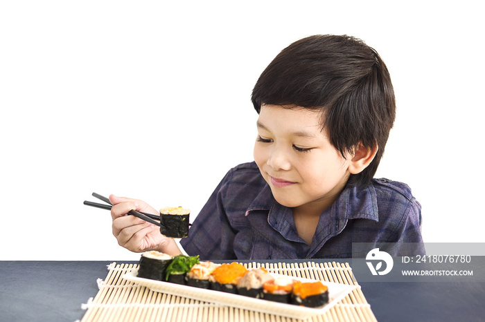 Asian lovely boy is eating sushi over white background