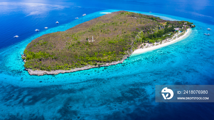 Aerial view of the Sumilon island, sandy beach with tourists swimming in beautiful clear sea water o