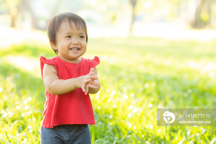 Portrait face of cute asian little girl and child happiness and fun in the park in the summer, smile