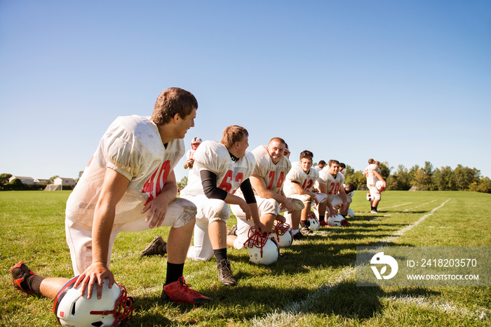 Smiling American football players in field