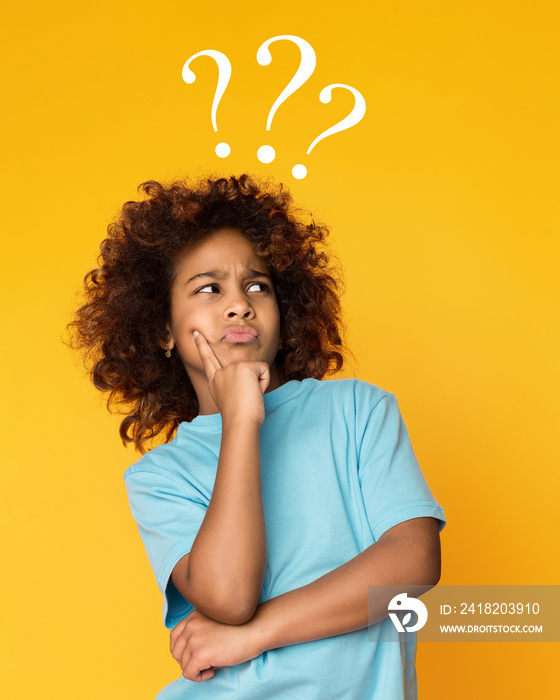 Child girl having questions over yellow background