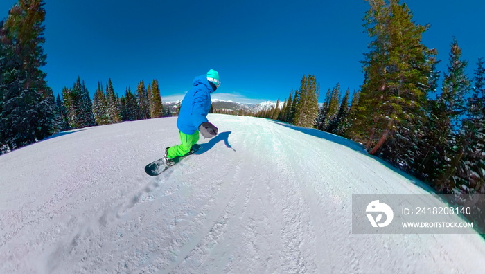 SELFIE: Unrecognizable snowboarder rides down a groomed trail on Copper Mountain