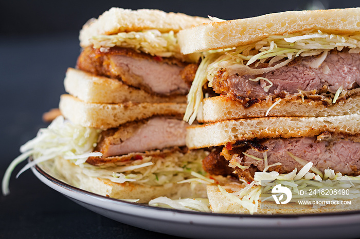 Katsu Sando - food trend japanese sandwich with breaded pork chop, cabbage and tonkatsu sauce. Japan